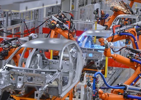 robots welding in an automobile factory